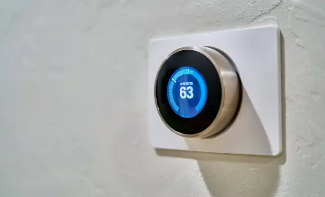 gray Nest thermostat displaying at 63